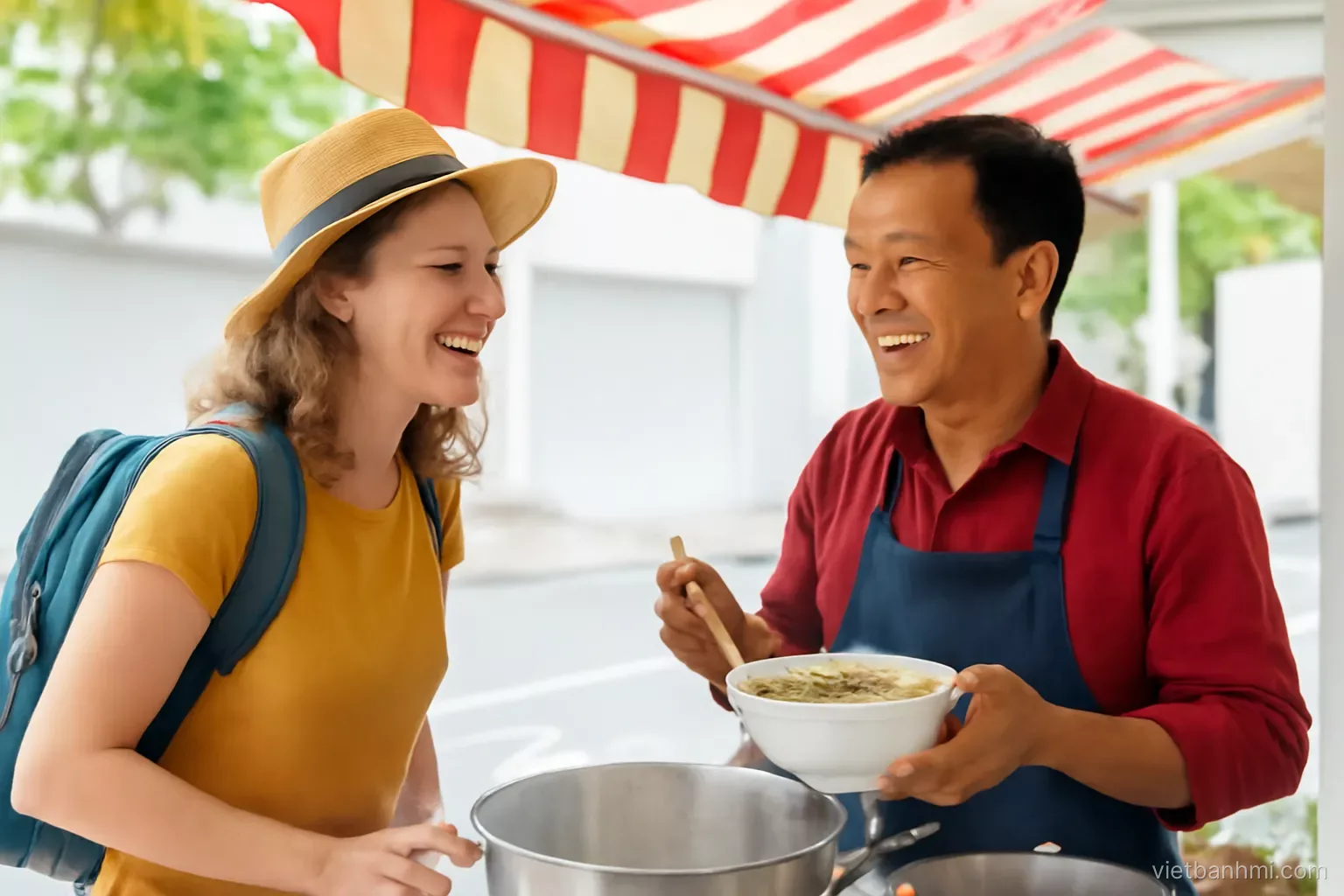 Smiling traveller speaking with a friendly Vietnamese noodle-stall owner under a bright awning, both laughing, over-the-shoulder angle, steam rising from pots, airy modern editorial.